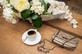 A ÃÂup of coffee with lemon and sugar next to a glass of white wine, bouquet of artificial flowers and a woman`s bag Royalty Free Stock Photo